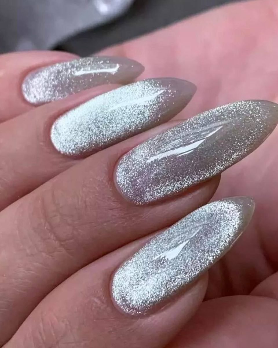 Long almond nails with a silver cat eye effect