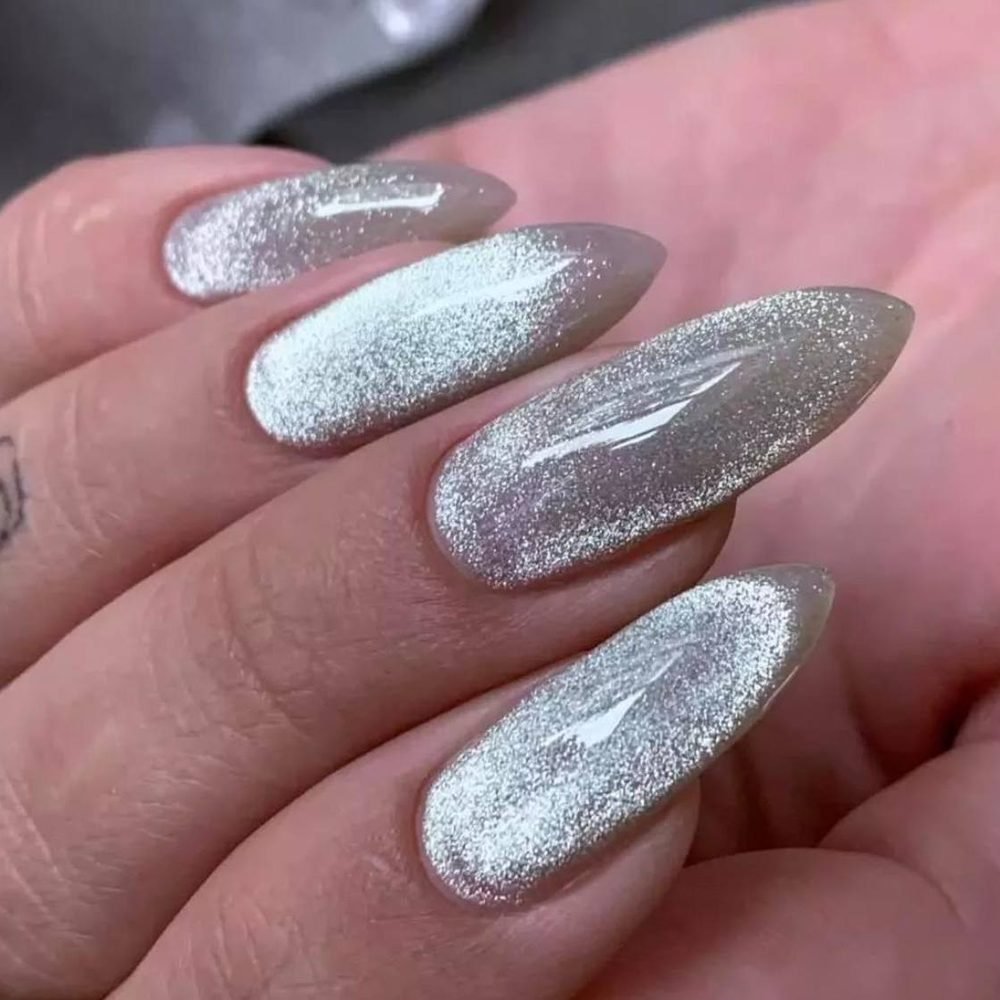 Long almond nails with a silver cat eye effect