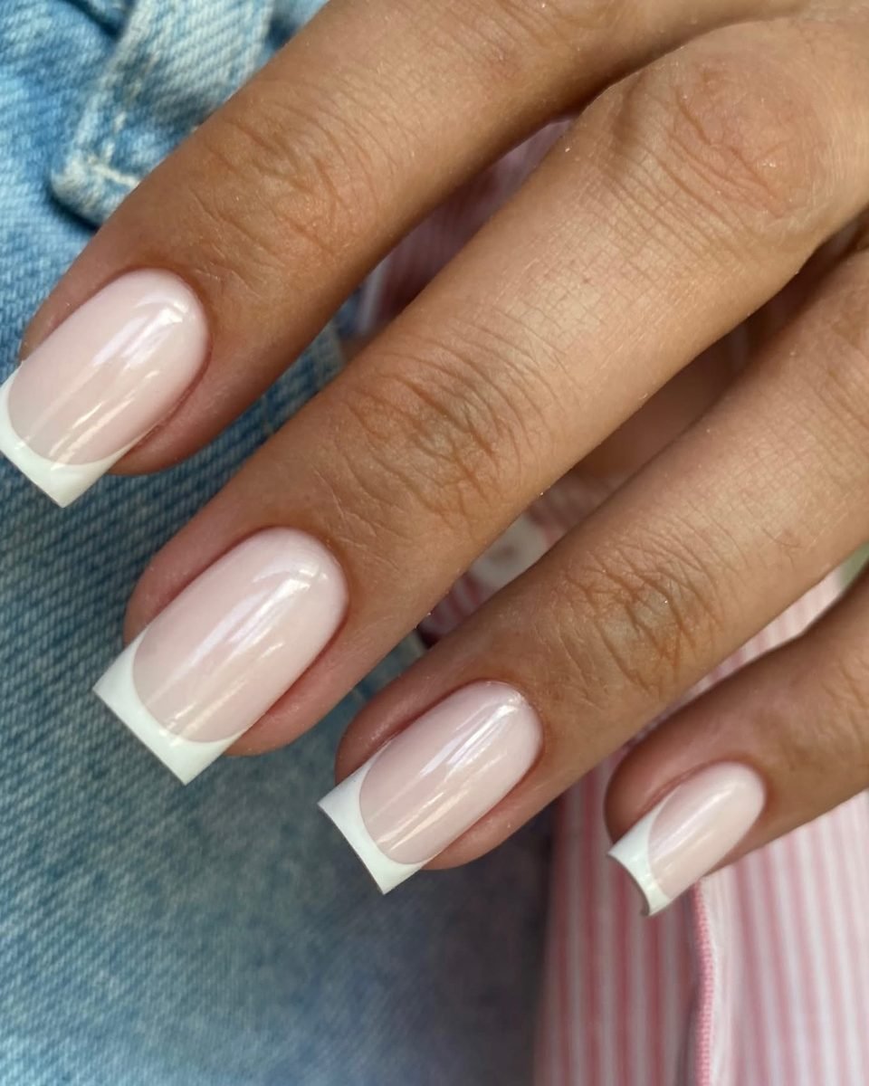 Short square nails with a milky base and thin white French tips
