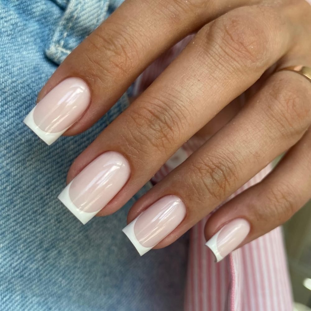Short square nails with a milky base and thin white French tips