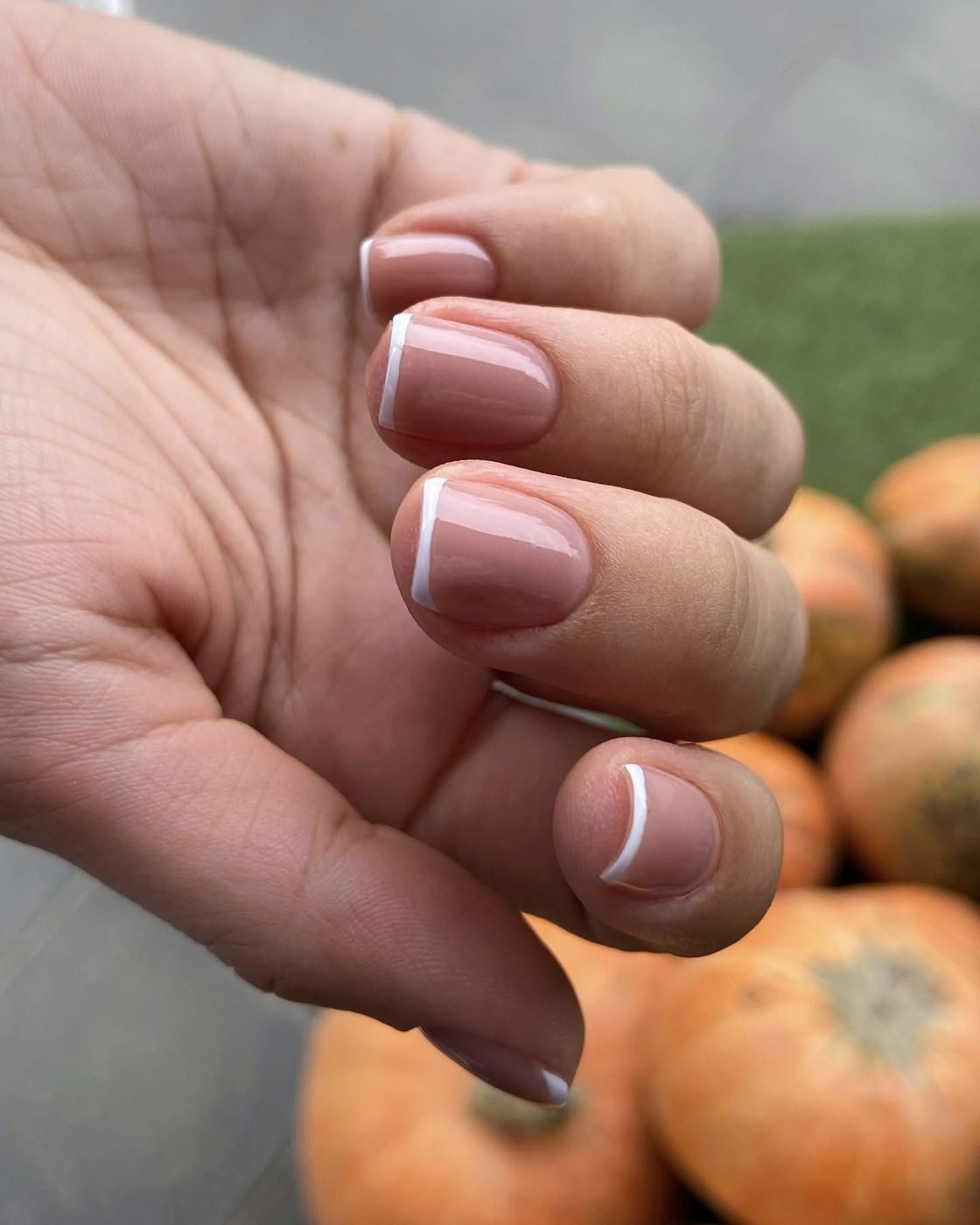 Nude nails with a thin white micro French tip