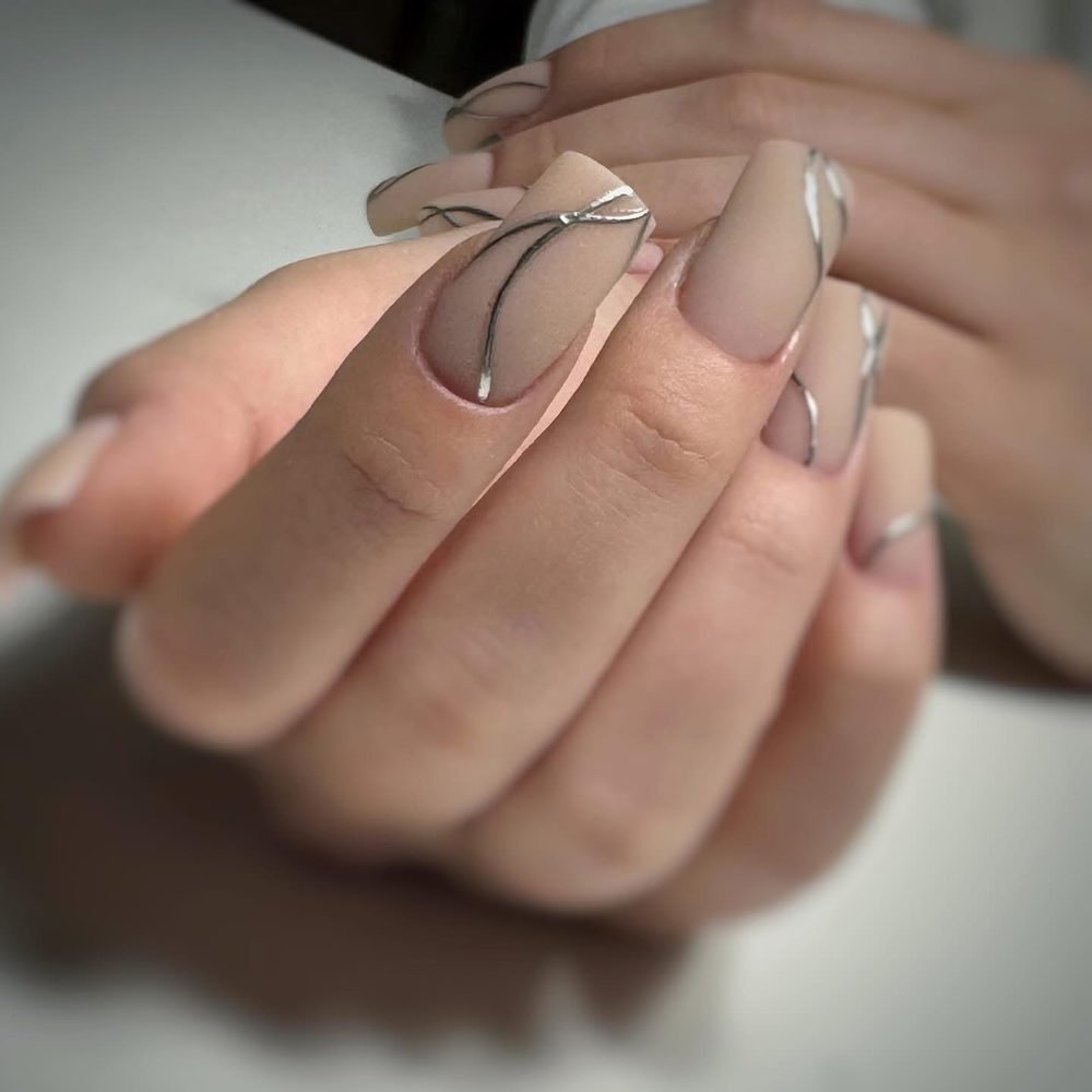 Nude almond nails with thin silver line art