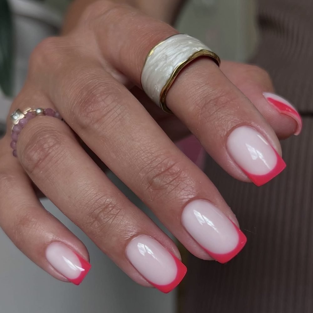 Milky nails with a bright pink French tip