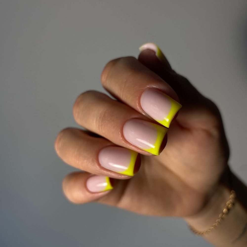 Sheer nails with neon yellow French tips